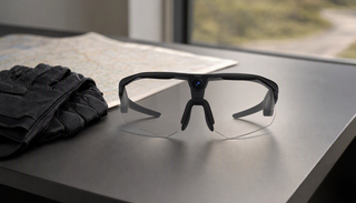 BleeqUp Ranger camera glasses arranged with cycling gear and a route map